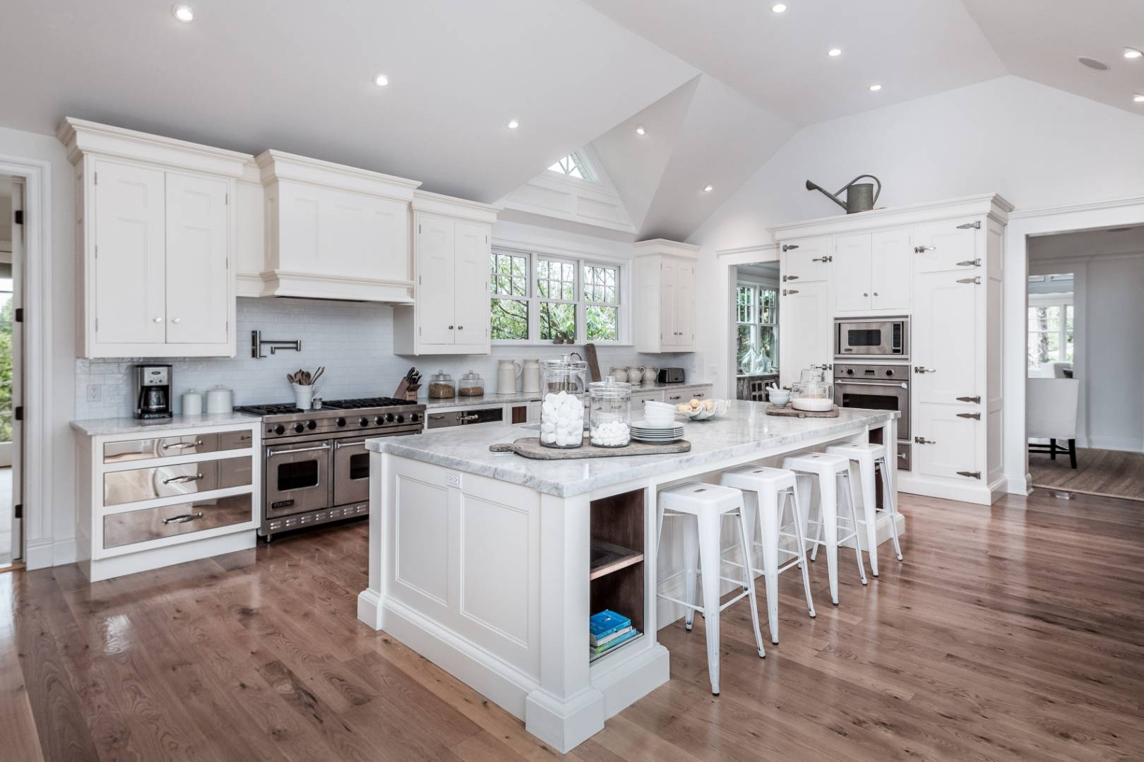 933 Cobb Road West Water Mill, NY 11976 - Photo 11 of 26 a kitchen with stainless steel appliances kitchen island granite countertop a stove top oven a sink dishwasher and a refrigerator with wooden floor