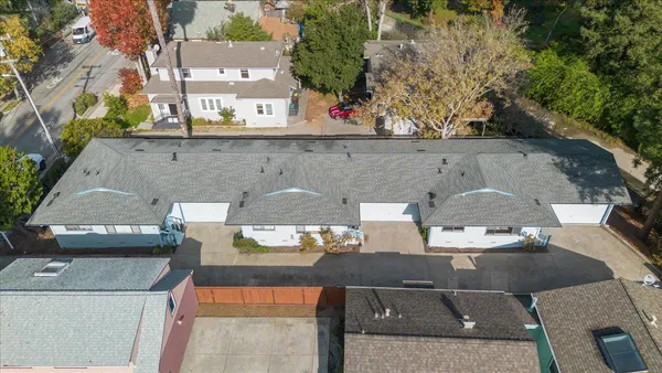 an aerial view of a house with a yard