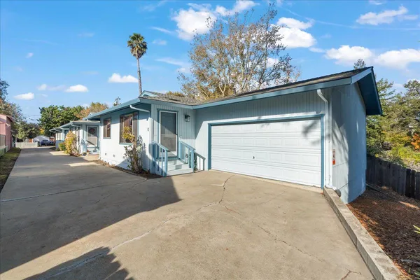 a view of a house with a outdoor space and garage