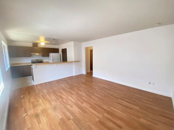 a view of a kitchen with a sink and a refrigerator