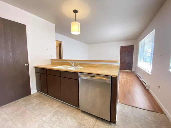 a kitchen with a sink cabinets and a window