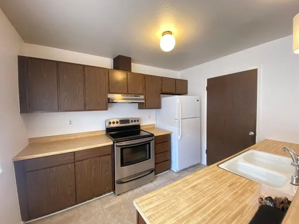 a kitchen with a sink appliances and cabinets