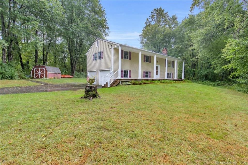 a view of a house with a backyard