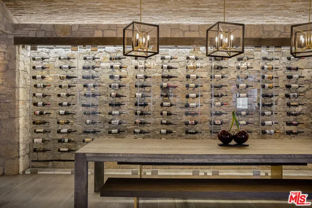 a living room with furniture a wooden floor and a large window