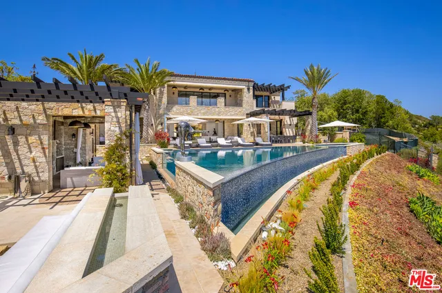 a view of a swimming pool with outdoor seating