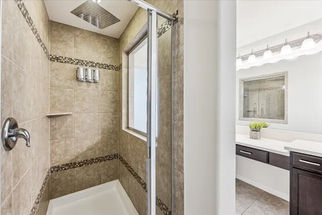 a bathroom with a tub shower vanity and a sink