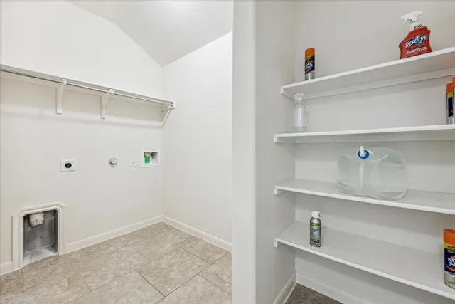 a view of storage and utility room with racks on the wall