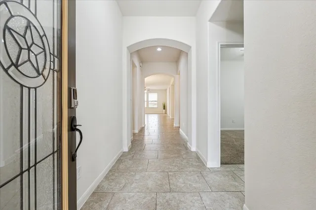 a view of a hallway with wooden shelves