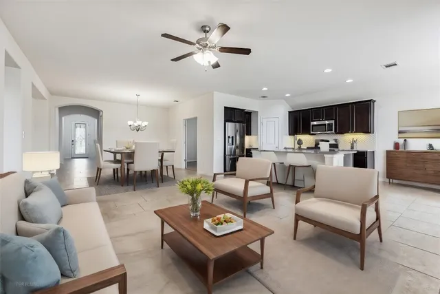 a living room with furniture and kitchen view