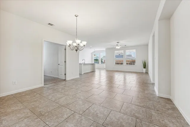 a view of a kitchen with a stove cabinets and a chandelier