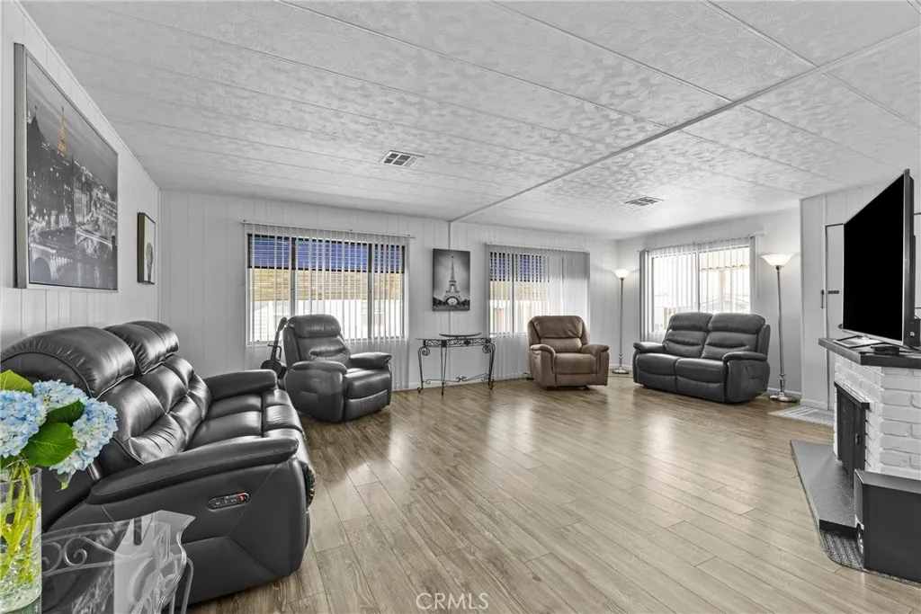 4000 Pierce Street, Unit 132 Riverside, CA 92505 - Photo 11 of 43 a living room with furniture and a flat screen tv