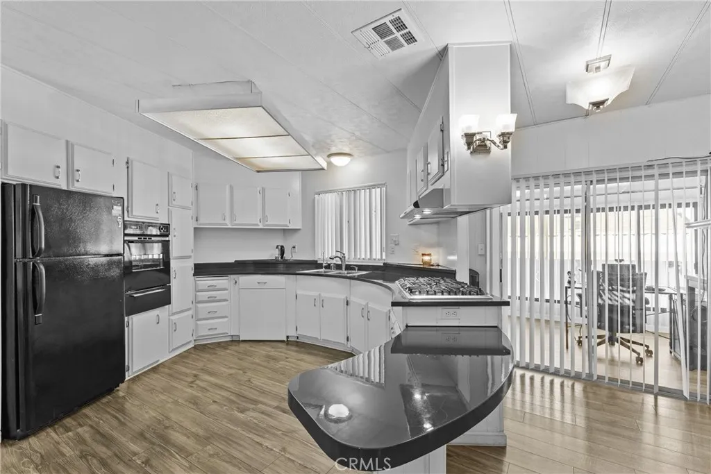 4000 Pierce Street, Unit 132 Riverside, CA 92505 - Photo 15 of 43 a kitchen with stainless steel appliances granite countertop a sink a stove and refrigerator