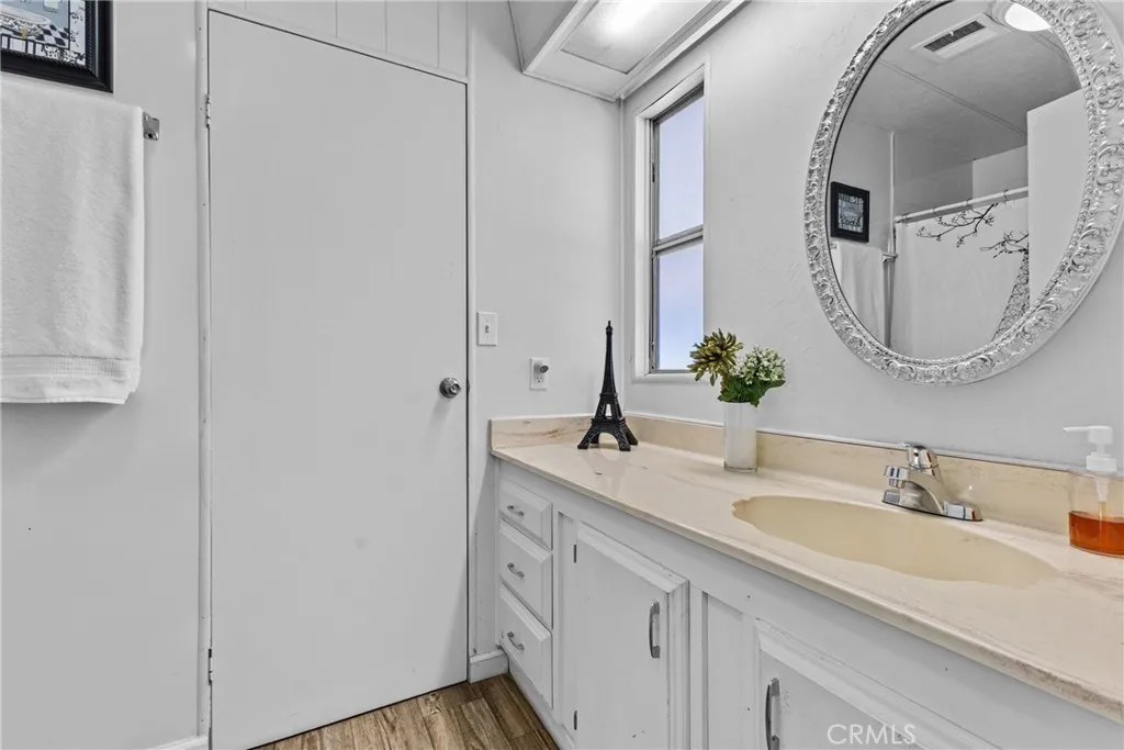 4000 Pierce Street, Unit 132 Riverside, CA 92505 - Photo 21 of 43 a bathroom with a double vanity sink and mirror
