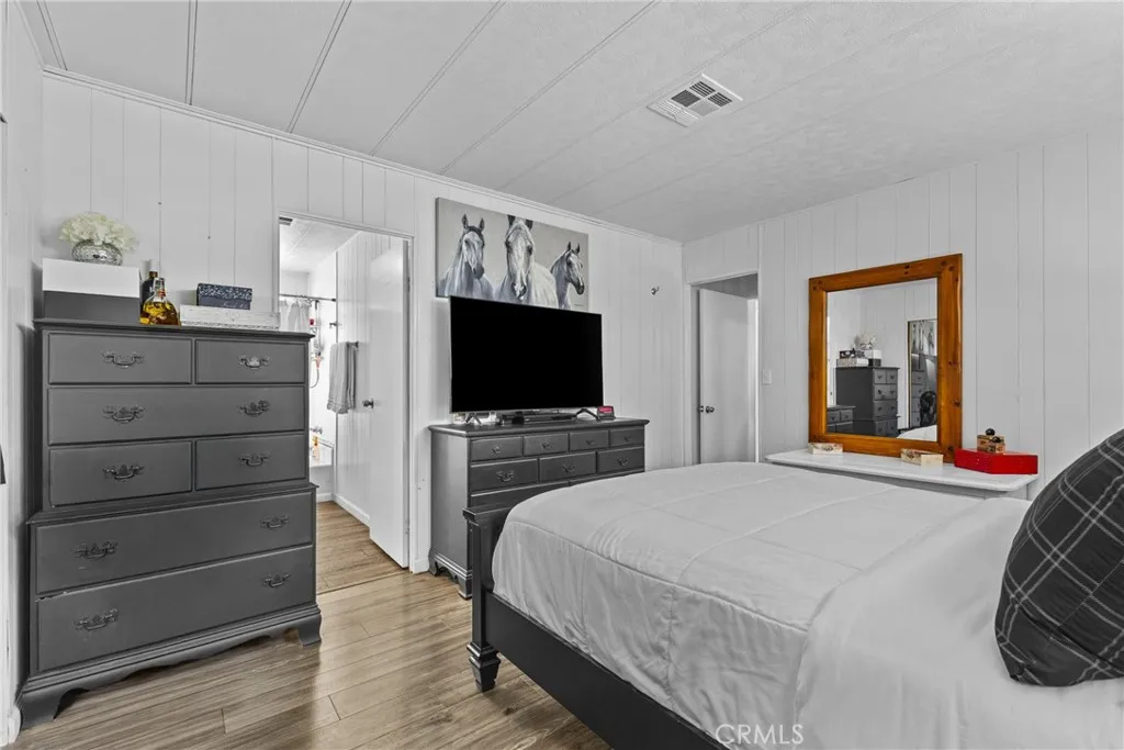 4000 Pierce Street, Unit 132 Riverside, CA 92505 - Photo 25 of 43 a bedroom with a bed and a flat screen tv