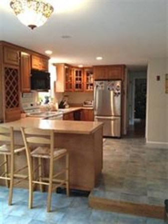 2 Jackson Road Scituate, MA 02066 - Photo 7 of 13 a kitchen with stainless steel appliances granite countertop a refrigerator and a stove top oven