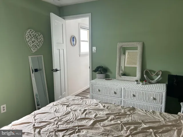 a bedroom with a bed and a dresser