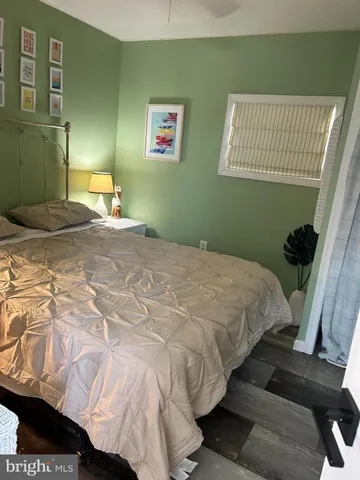 a bedroom with a bed and a mirror