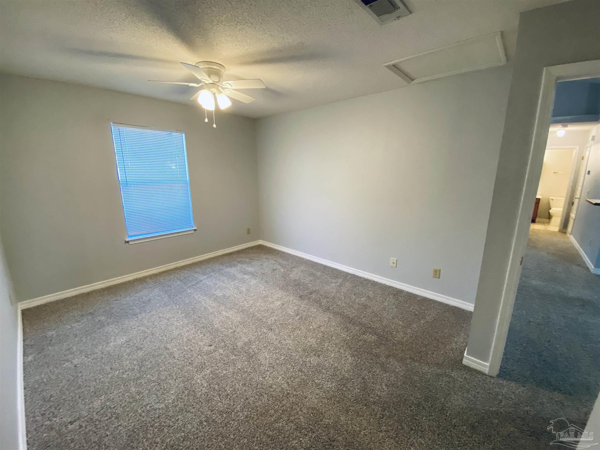 1000 Sable Drive, Unit B Pensacola, FL 32514 - Photo 7 of 10 an empty room with windows and fan