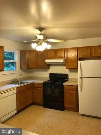 a kitchen with stainless steel appliances a sink and a refrigerator