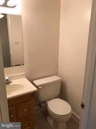 a white toilet sitting next to a bathroom sink