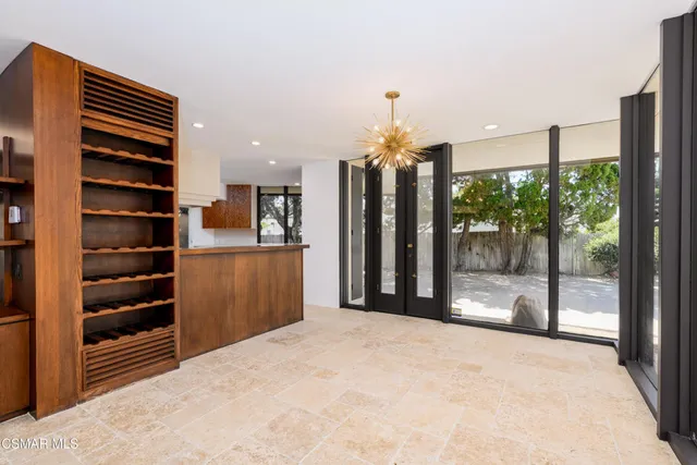 a kitchen with a refrigerator and a stove top oven