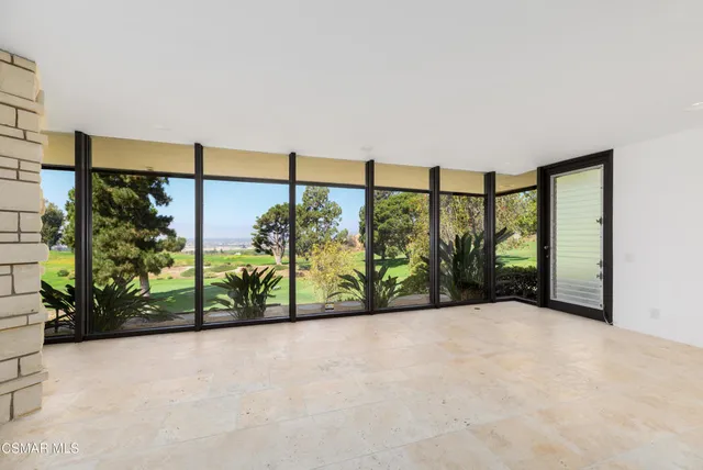 a view of a house with a yard and potted plants