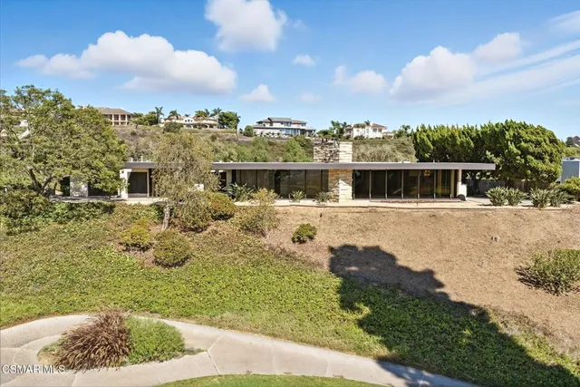 a view of an empty room with windows and flat screen tv