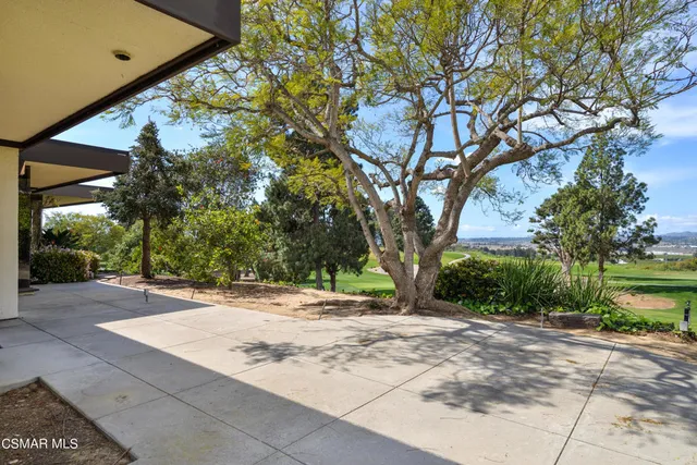 a view of a backyard with sitting area