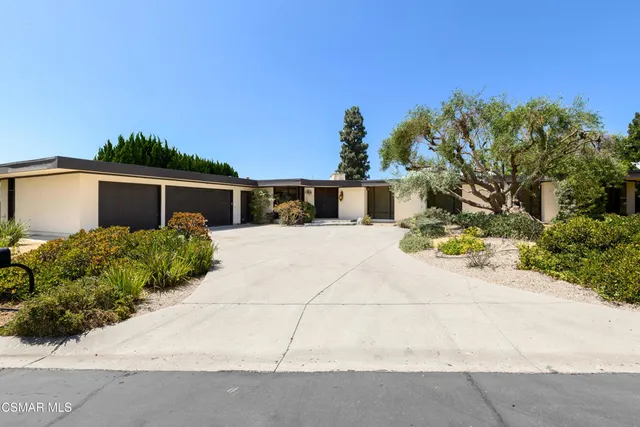 a view of an empty room with a fireplace and a large window
