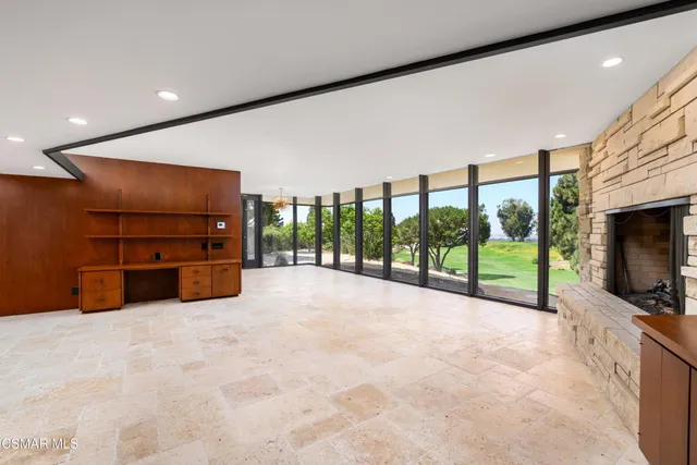a view of a room with window and a ceiling fan