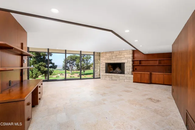 a view of an empty room with a sliding door and wooden floor