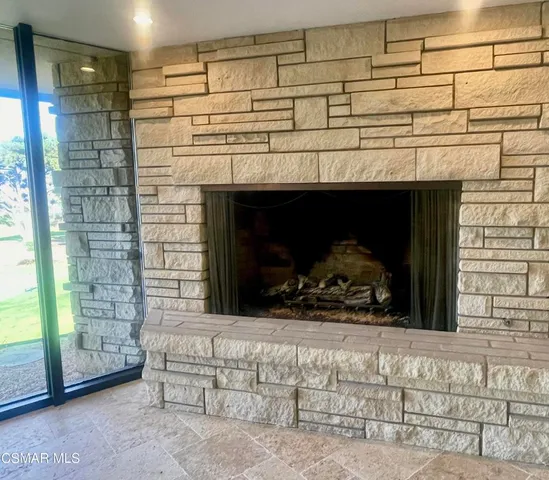 a view of an empty room with window and a bathroom