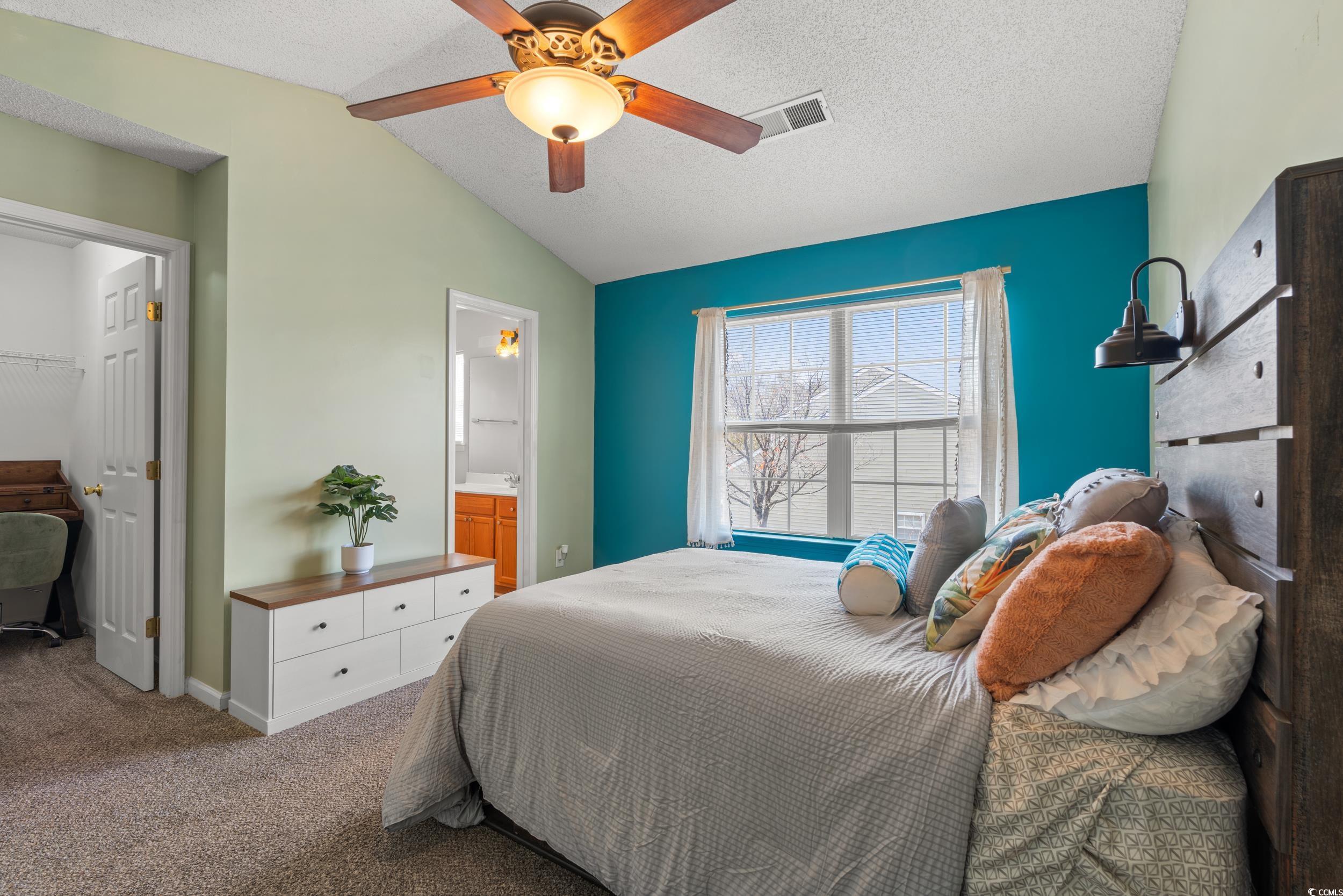 270 Seabert Road, Unit 270 Myrtle Beach, SC 29579 - Photo 12 of 31 Carpeted bedroom featuring vaulted ceiling, a textured ceiling, and ceiling fan