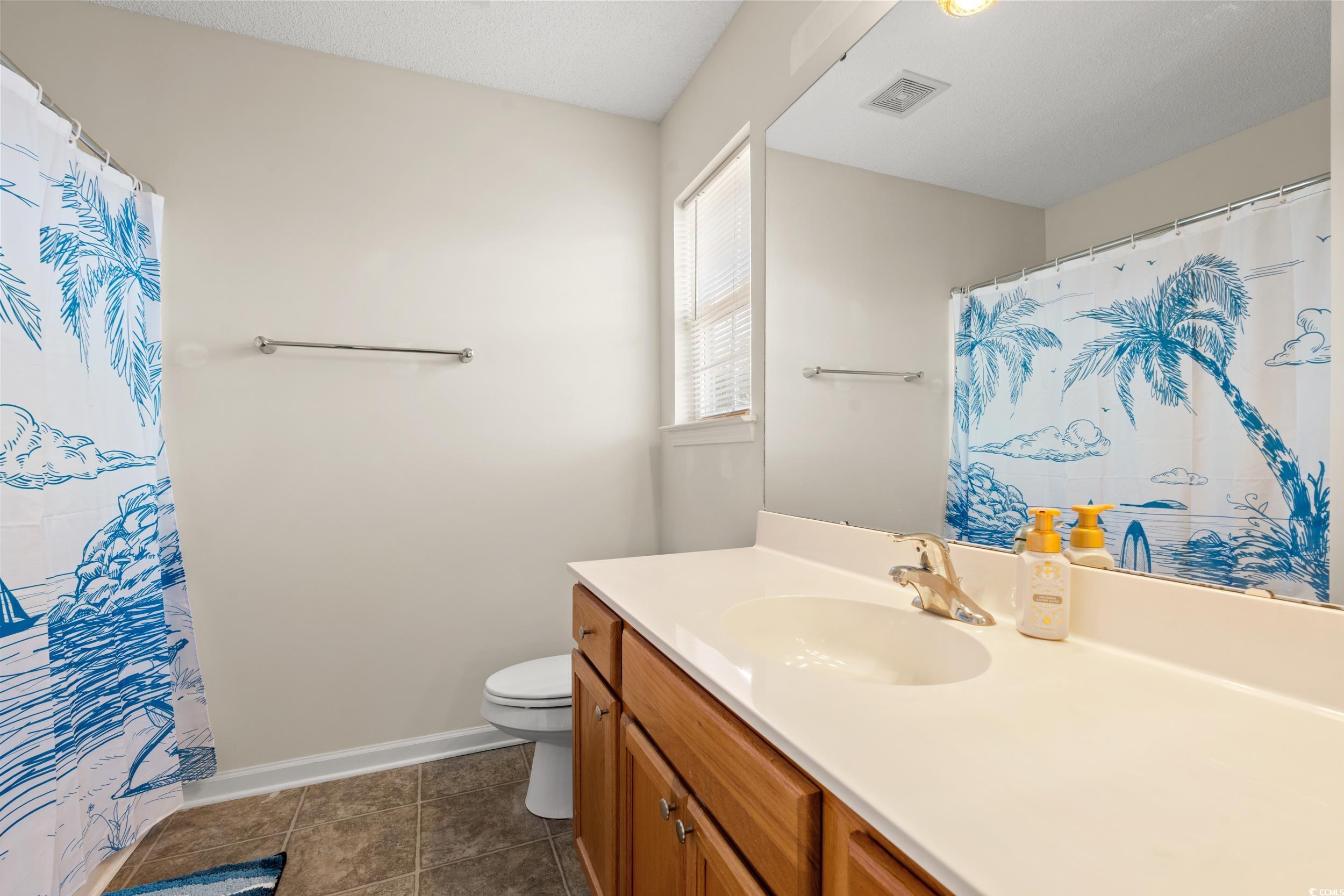 270 Seabert Road, Unit 270 Myrtle Beach, SC 29579 - Photo 14 of 31 Carpeted bedroom featuring a ceiling fan, lofted ceiling, and a textured ceiling