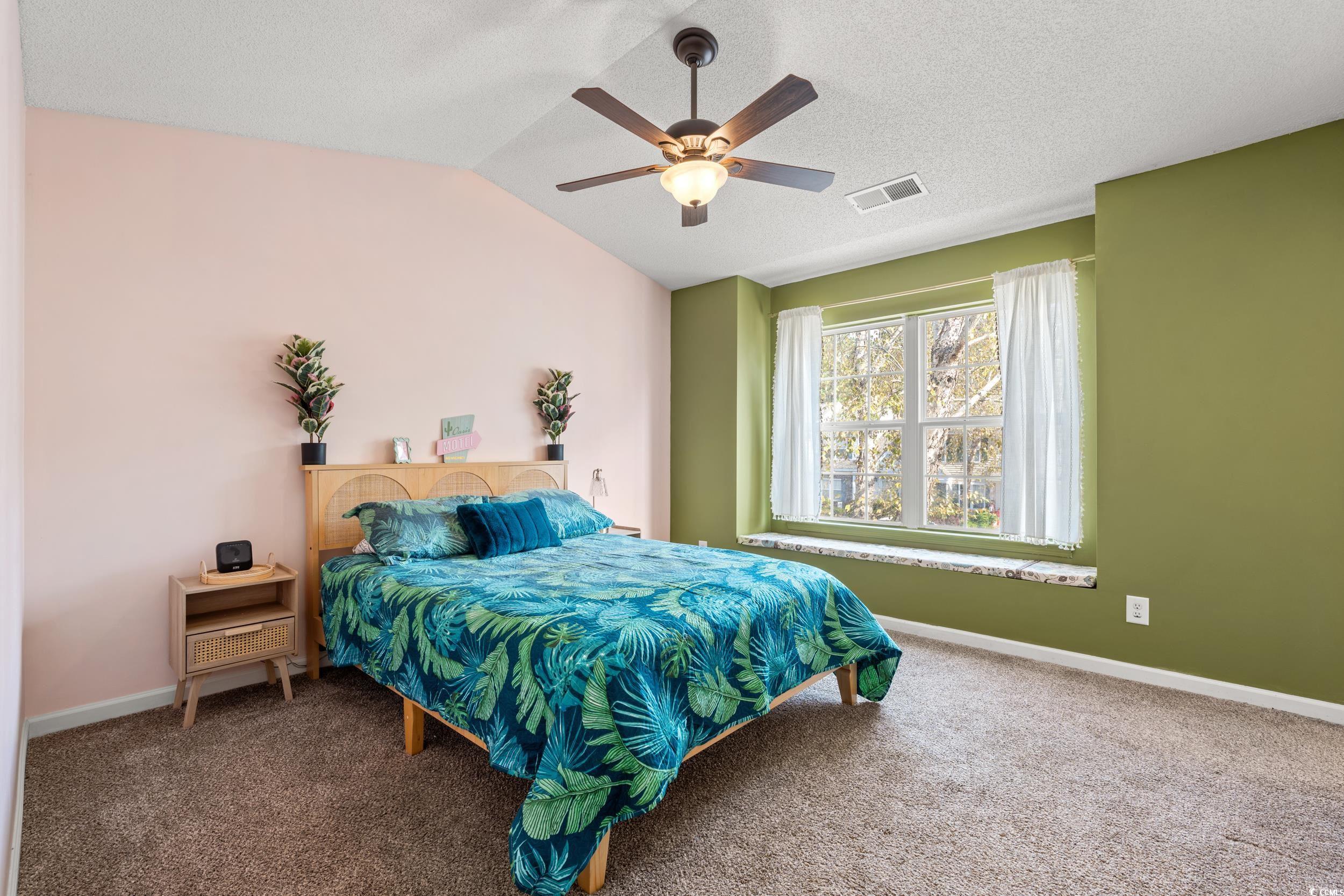 270 Seabert Road, Unit 270 Myrtle Beach, SC 29579 - Photo 18 of 31 Carpeted bedroom with vaulted ceiling, a ceiling fan, and a textured ceiling