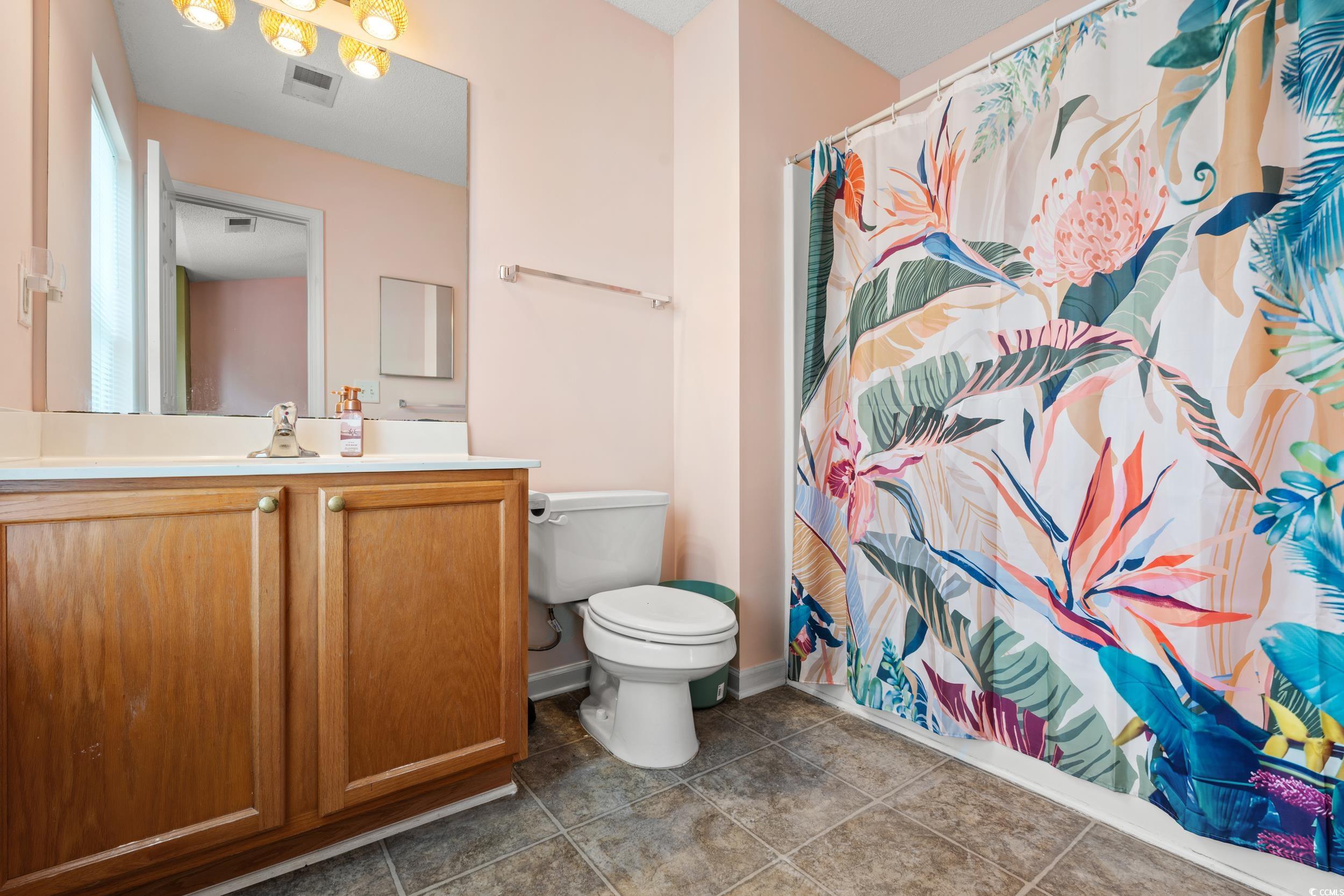 270 Seabert Road, Unit 270 Myrtle Beach, SC 29579 - Photo 19 of 31 Bedroom featuring carpet floors, a ceiling fan, lofted ceiling, and a textured ceiling