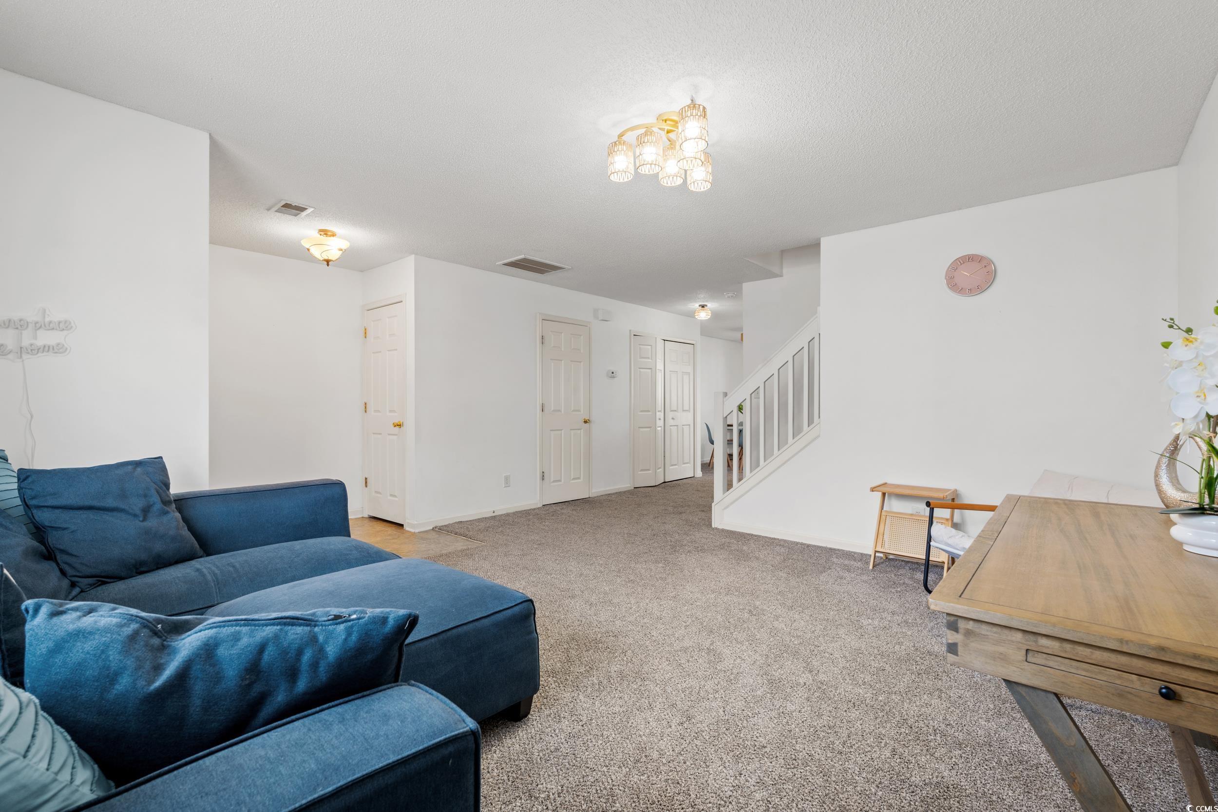 270 Seabert Road, Unit 270 Myrtle Beach, SC 29579 - Photo 4 of 31 Living room with light colored carpet and stairway