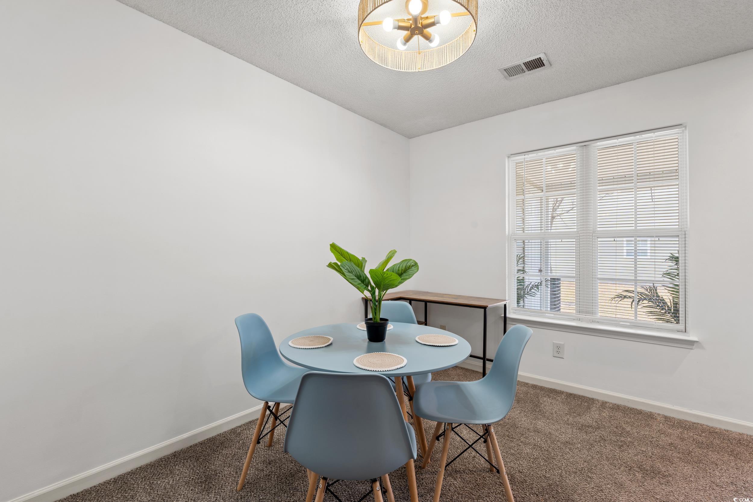 270 Seabert Road, Unit 270 Myrtle Beach, SC 29579 - Photo 6 of 31 Kitchen with dark countertops, white appliances, a textured ceiling, brown cabinets, and dark wood-type flooring