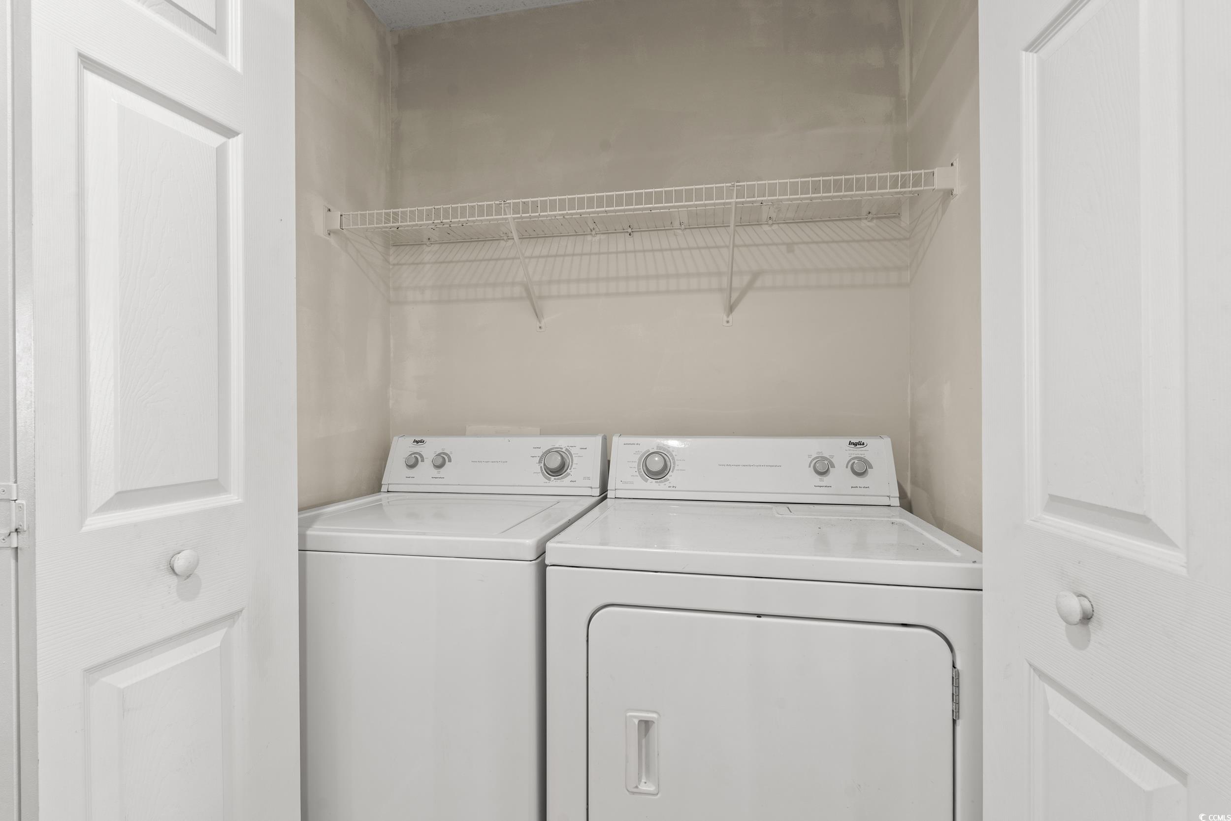 270 Seabert Road, Unit 270 Myrtle Beach, SC 29579 - Photo 9 of 31 Kitchen featuring recessed lighting, a kitchen bar, white refrigerator with ice dispenser, dark countertops, and brown cabinets