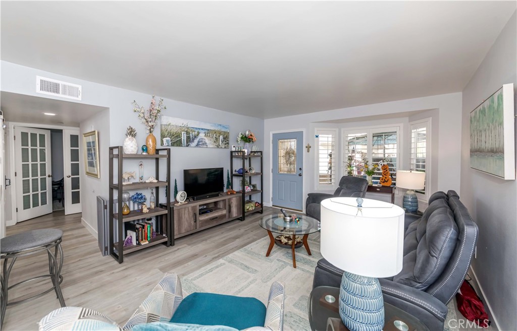12671 Briarglen Loop, Unit G Stanton, CA 90680 - Photo 11 of 24 a living room with furniture and a flat screen tv