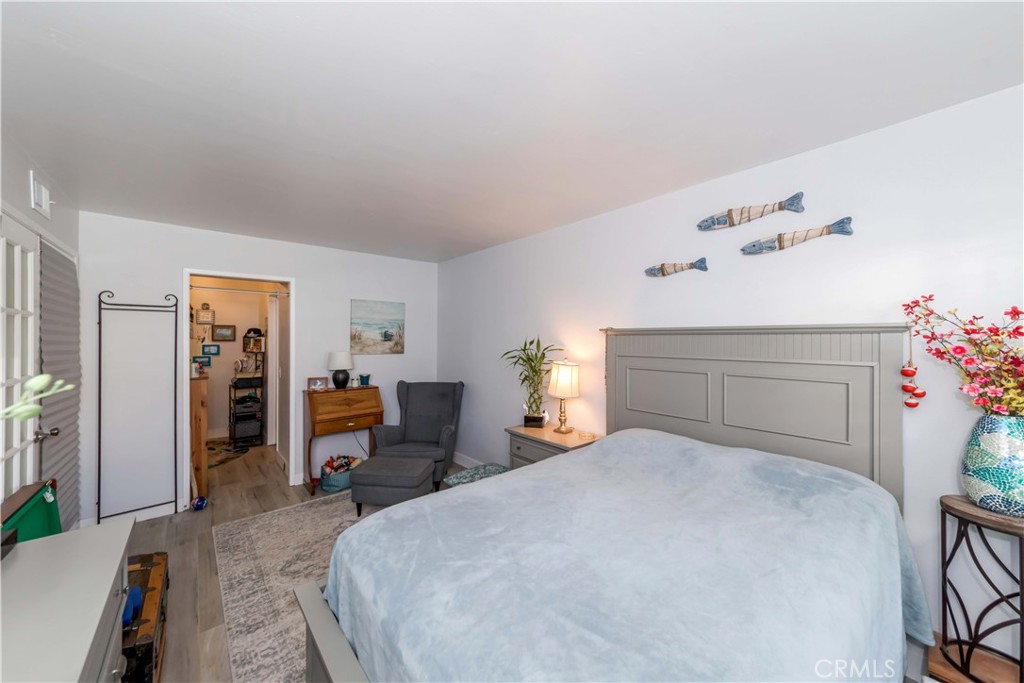 12671 Briarglen Loop, Unit G Stanton, CA 90680 - Photo 14 of 24 a bedroom with a bed and table chair