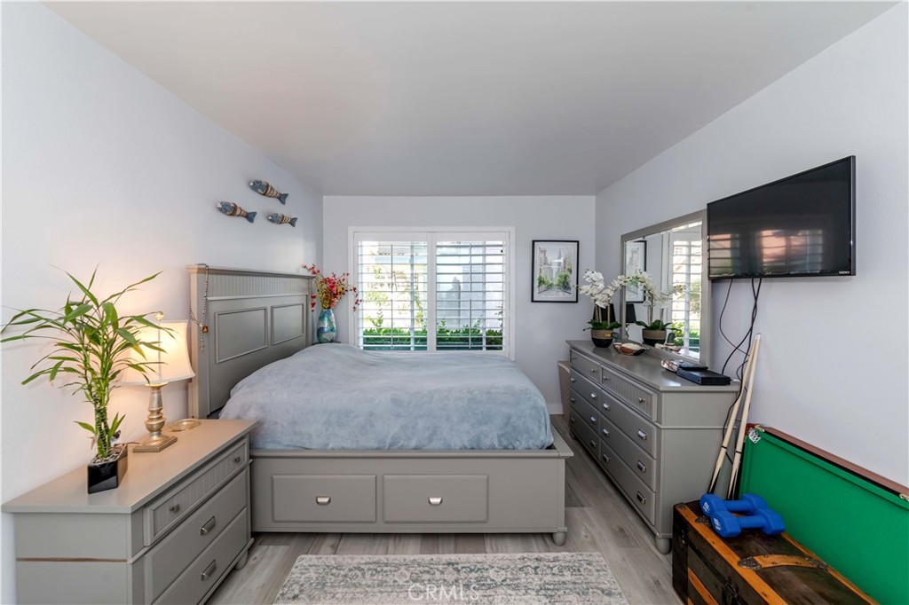 12671 Briarglen Loop, Unit G Stanton, CA 90680 - Photo 16 of 24 a living room with furniture and a flat screen tv
