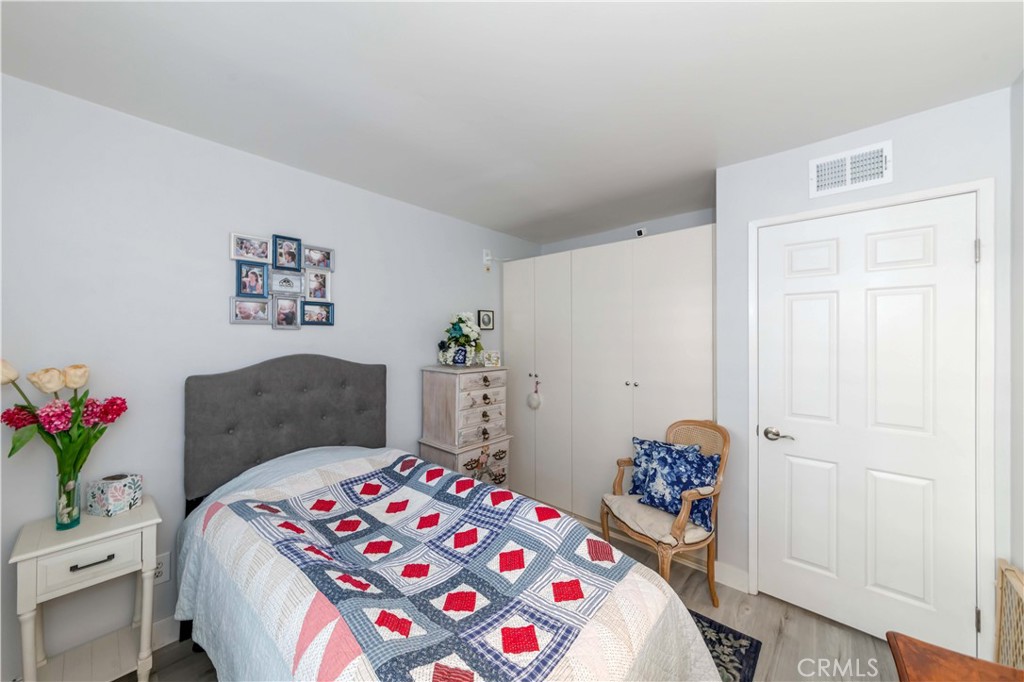 12671 Briarglen Loop, Unit G Stanton, CA 90680 - Photo 19 of 24 a bedroom with a bed and a dresser