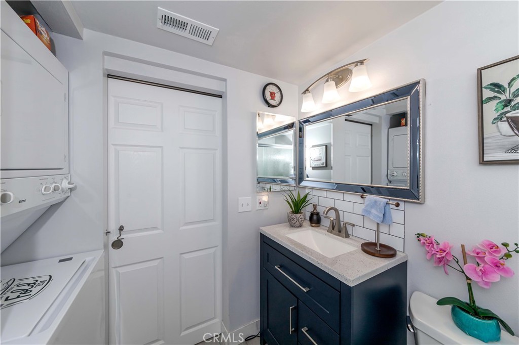 12671 Briarglen Loop, Unit G Stanton, CA 90680 - Photo 20 of 24 a bathroom with a sink vanity and a mirror