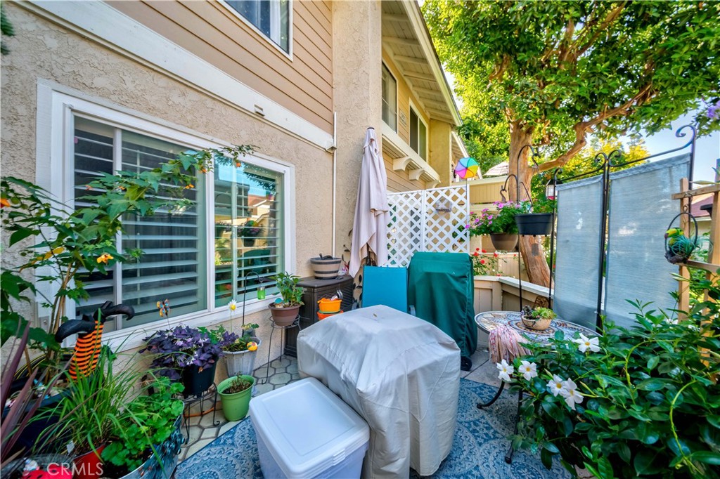 12671 Briarglen Loop, Unit G Stanton, CA 90680 - Photo 2 of 24 a view of a chair and table in backyard of the house