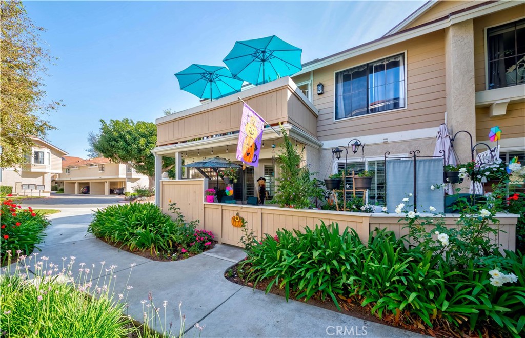 12671 Briarglen Loop, Unit G Stanton, CA 90680 - Photo 4 of 24 a front view of a house with garden
