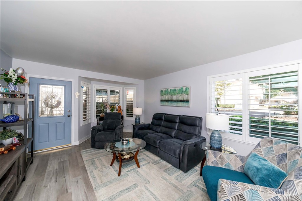 12671 Briarglen Loop, Unit G Stanton, CA 90680 - Photo 5 of 24 a living room with furniture and a window