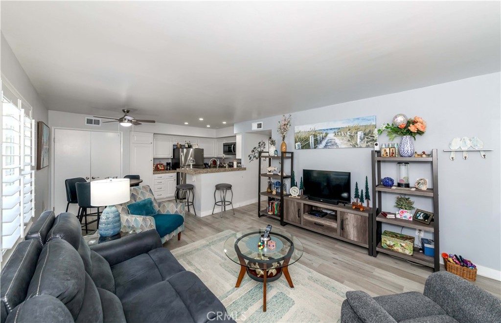 12671 Briarglen Loop, Unit G Stanton, CA 90680 - Photo 6 of 24 a living room with furniture and a flat screen tv