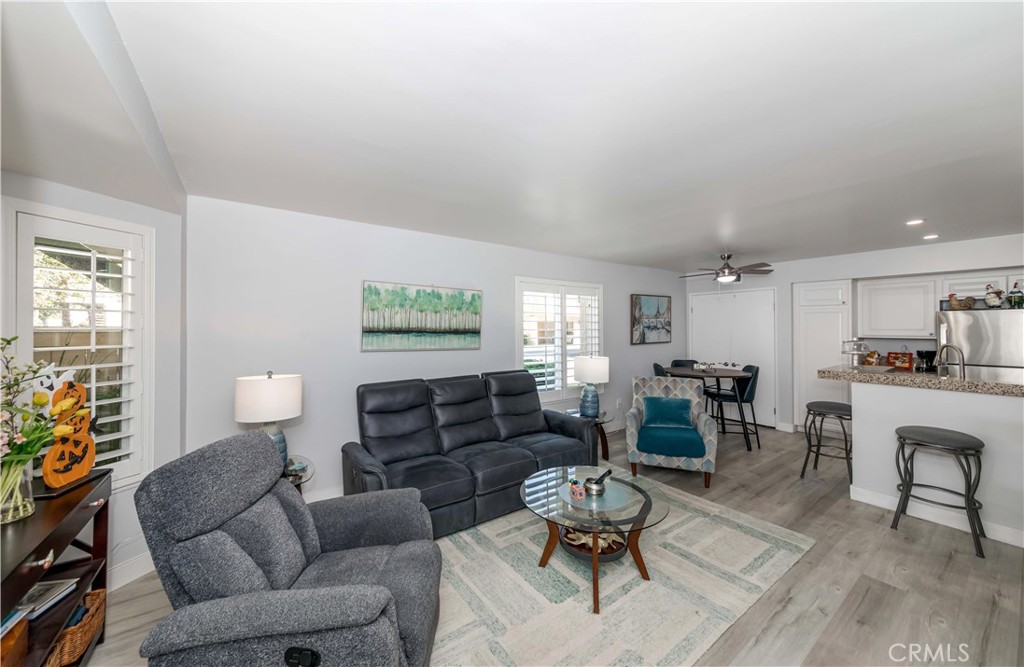 12671 Briarglen Loop, Unit G Stanton, CA 90680 - Photo 8 of 24 a living room with furniture dining table and a window