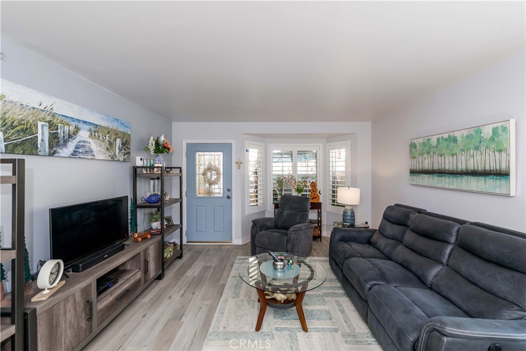 12671 Briarglen Loop, Unit G Stanton, CA 90680 - Photo 9 of 24 a living room with furniture and a flat screen tv
